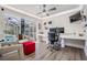Bright office opens to pool and features hardwood flooring, a ceiling fan and built-in desk at 1123 Hounds Run, Safety Harbor, FL 34695