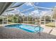 Enjoy the refreshing pool with screened-in enclosure, offering privacy and relaxation; an outdoor oasis at 1123 Hounds Run, Safety Harbor, FL 34695