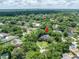Aerial view of a luxurious home with a private pool surrounded by lush trees, offering a serene retreat at 11806 Willow Point Way, Tampa, FL 33618