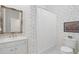 Cozy bathroom with white vanity, floral wallpaper and shower with curtain at 11806 Willow Point Way, Tampa, FL 33618