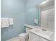 Bathroom with single sink, large mirror and a shower/tub with a curtain at 11806 Willow Point Way, Tampa, FL 33618