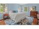 Bedroom with hard wood floors, bright blue walls and matching area rug at 11806 Willow Point Way, Tampa, FL 33618