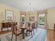 Formal dining room boasts a chandelier, large mirror, and seating for six at 11806 Willow Point Way, Tampa, FL 33618