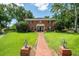 Charming brick home featuring a well-manicured lawn, brick pathway, and inviting front entrance at 11806 Willow Point Way, Tampa, FL 33618