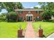 Two-story brick home with a manicured lawn and a brick walkway leading to the front door at 11806 Willow Point Way, Tampa, FL 33618