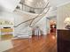 Spacious foyer featuring a grand staircase, hardwood floors, and elegant decor at 11806 Willow Point Way, Tampa, FL 33618