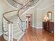 Spacious foyer with winding staircase, chandelier, hardwood floors, and floral wallpaper at 11806 Willow Point Way, Tampa, FL 33618