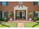 Inviting front entrance with a classic brick walkway, decorative plants, and elegant architectural details at 11806 Willow Point Way, Tampa, FL 33618