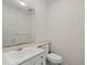 Cozy half bath features a vanity sink and toilet with elegant wallpaper, providing a charming touch to the space at 11806 Willow Point Way, Tampa, FL 33618