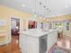 Large kitchen island features granite countertops, pendant lighting and a dishwasher at 11806 Willow Point Way, Tampa, FL 33618