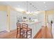 Open kitchen features white cabinets, stainless steel appliances, and a large center island at 11806 Willow Point Way, Tampa, FL 33618