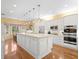 Spacious kitchen features white cabinets, granite countertops, stainless steel appliances, and hardwood floors at 11806 Willow Point Way, Tampa, FL 33618