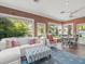 Cozy living room with a brick floor, comfortable seating, and a view of the pool at 11806 Willow Point Way, Tampa, FL 33618