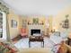Bright living room featuring a fireplace, hardwood floors, and comfortable seating at 11806 Willow Point Way, Tampa, FL 33618