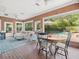 Bright brick living room with pool views, comfortable seating, and access to the outdoors at 11806 Willow Point Way, Tampa, FL 33618