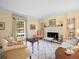 Bright living room featuring a fireplace, hardwood floors, and comfortable seating at 11806 Willow Point Way, Tampa, FL 33618