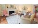 Bright living room featuring a fireplace, hardwood floors, and comfortable seating at 11806 Willow Point Way, Tampa, FL 33618