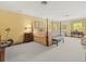 Spacious main bedroom with a four poster bed, sitting area and soft, bright colors at 11806 Willow Point Way, Tampa, FL 33618