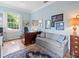 Home office with hardwood floors, blue walls, and comfortable seating area at 11806 Willow Point Way, Tampa, FL 33618