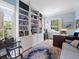 Well-lit home office with custom built-in bookshelves and desk space at 11806 Willow Point Way, Tampa, FL 33618