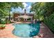 Backyard features a large swimming pool, patio furniture, and well-maintained landscaping at 11806 Willow Point Way, Tampa, FL 33618
