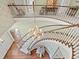 Elegant staircase with a chandelier, hardwood floors and unique floral wallpaper at 11806 Willow Point Way, Tampa, FL 33618
