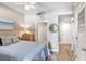 Serene bedroom featuring a comfortable bed, wooden dresser, and an en-suite bathroom with natural light at 1208 E Kennedy Blvd # 1017, Tampa, FL 33602