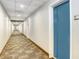 Long hallway with neutral colored walls and doors to multiple units at 1208 E Kennedy Blvd # 1017, Tampa, FL 33602