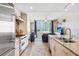 Open kitchen with stainless steel appliances flowing into a sunlit living room with city views at 1208 E Kennedy Blvd # 1017, Tampa, FL 33602