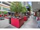 Outdoor lounge area with comfortable seating, mature landscaping, and nearby shops at 1208 E Kennedy Blvd # 1017, Tampa, FL 33602