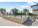 Rooftop pool area with a plunge pool, railing, lush palms and easy access from staircase at 1208 E Kennedy Blvd # 1017, Tampa, FL 33602
