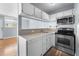 Kitchen view featuring white cabinets, stainless steel appliances, and ample counter space at 1301 S Howard Ave # C10, Tampa, FL 33606