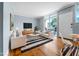 Bright, staged living room with modern furnishings and a sliding glass door at 1301 S Howard Ave # C10, Tampa, FL 33606