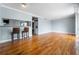 Open-concept living area with breakfast bar, hardwood floors, and lots of light at 1301 S Howard Ave # C10, Tampa, FL 33606