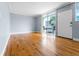 A clean and bright unfurnished living room with hardwood flooring and a sliding glass door at 1301 S Howard Ave # C10, Tampa, FL 33606