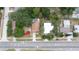 Captivating aerial view of a charming home with a refreshing swimming pool nestled among lush trees at 1312 Gulf Rd, Tarpon Springs, FL 34689
