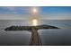 Scenic aerial view of a road leading to a tranquil island under a radiant sun and blue sky at 1312 Gulf Rd, Tarpon Springs, FL 34689
