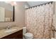 Bathroom showcasing a vanity with granite countertop and shower with decorative curtain at 1312 Gulf Rd, Tarpon Springs, FL 34689