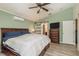 Cozy bedroom featuring laminate floors, a ceiling fan, and fresh paint at 1312 Gulf Rd, Tarpon Springs, FL 34689