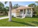 Inviting home with front porch, lush lawn, and attached garage at 1312 Gulf Rd, Tarpon Springs, FL 34689