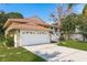 Charming home featuring a large driveway and attached garage at 1312 Gulf Rd, Tarpon Springs, FL 34689