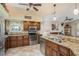 Kitchen with stainless steel appliances, granite countertops, tiled backsplash, and breakfast bar at 1312 Gulf Rd, Tarpon Springs, FL 34689