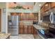 Bright kitchen featuring stainless steel appliances, granite countertops, and ample cabinet space at 1312 Gulf Rd, Tarpon Springs, FL 34689