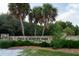 The Fred H. Howard Park sign is framed by palm trees and lush greenery, inviting visitors at 1312 Gulf Rd, Tarpon Springs, FL 34689