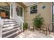 Back patio featuring potted plants, outdoor chairs, and stairs to the main entry at 1312 Gulf Rd, Tarpon Springs, FL 34689