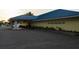 Exterior shot of the Tarpon Springs Yacht Club, featuring a covered entrance and ample parking at 1312 Gulf Rd, Tarpon Springs, FL 34689