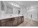 Bathroom featuring double sinks, dark cabinets, and a glass-enclosed walk-in shower at 14140 Canyon Swallow Rd, Weeki Wachee, FL 34614