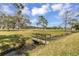 Backyard with a wooden bridge over a small creek at 1431 54Th Ne Ave, St Petersburg, FL 33703