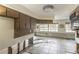 Spacious kitchen area with tiled floor, wooden cabinets and natural lighting at 1431 54Th Ne Ave, St Petersburg, FL 33703