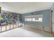 Spacious living room features an artistic accent wall and natural light from the window at 1431 54Th Ne Ave, St Petersburg, FL 33703